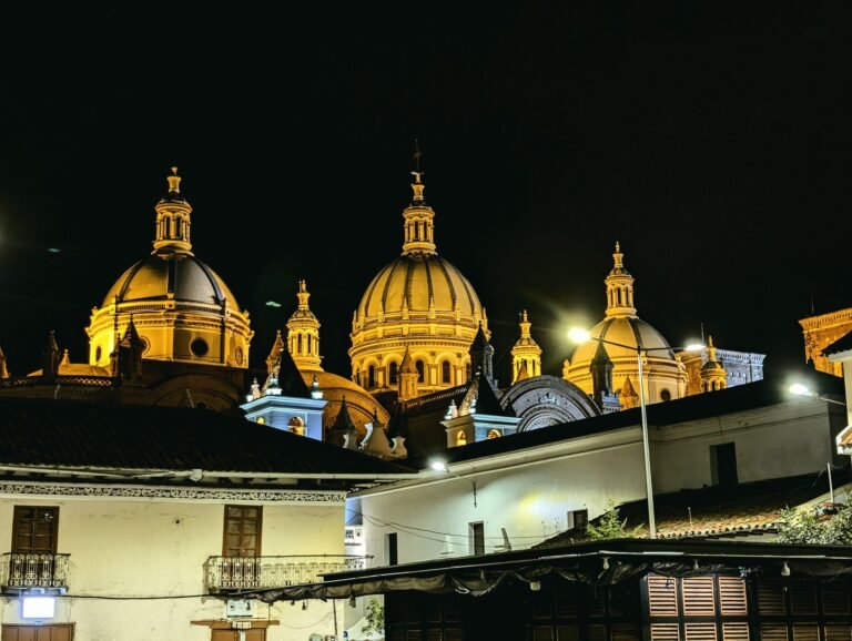 The lit blue domes of Cuenca's New Cathedral at night